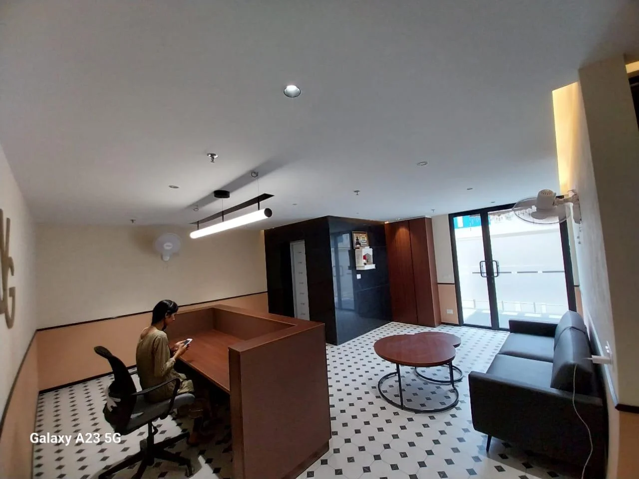 Custom reception desk and waiting lounge area in a completed office interior project in Noida.